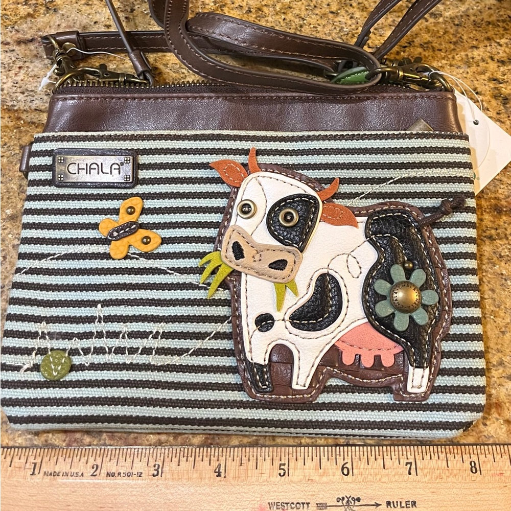 Chala small convertible crossbody handbag with cow appliqué
